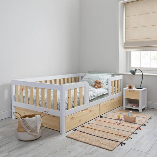 Is a floor bed with high sides better than a standard toddler bed for a child who rolls at night?